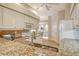 Bright kitchen with a breakfast bar, stainless steel appliances and light wood cabinets at 9411 Forest Hills Cir, Sarasota, FL 34238