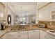 Kitchen features a breakfast bar with granite countertops, sink, and stainless steel appliances at 9411 Forest Hills Cir, Sarasota, FL 34238