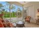 Inviting lanai with stylish outdoor furniture and a view of the beautifully landscaped backyard at 9411 Forest Hills Cir, Sarasota, FL 34238