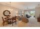 Open living area featuring a chandelier, comfortable seating, and seamless access to the lanai at 9411 Forest Hills Cir, Sarasota, FL 34238