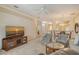 Bright living room with neutral walls, ceiling fan and comfortable seating area at 9411 Forest Hills Cir, Sarasota, FL 34238
