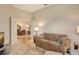 Comfortable living room with a couch, a view into the dining area, and plenty of natural light at 9411 Forest Hills Cir, Sarasota, FL 34238