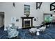 Elegant lounge featuring a cozy fireplace, comfortable seating, and stylish decor at 9411 Forest Hills Cir, Sarasota, FL 34238