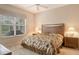 Comfortable bedroom features a window and two nightstands with lamps at 9411 Forest Hills Cir, Sarasota, FL 34238