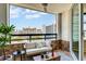 Cozy balcony with city view, comfortable seating, and table for relaxing at 988 Blvd Of The Arts # 1209, Sarasota, FL 34236