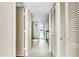 Hallway view of bathroom with shower, vanity, tile floor, and ocean view from end of hall at 988 Blvd Of The Arts # 1209, Sarasota, FL 34236