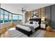 A bedroom featuring a wood accent wall, modern decor, and a stunning ocean view at 988 Blvd Of The Arts # 1209, Sarasota, FL 34236