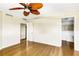 An empty bedroom shows wood floors and a ceiling fan near the closet and bathroom, ready for personalization at 988 Blvd Of The Arts # 1209, Sarasota, FL 34236