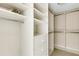 A large walk-in closet with custom shelving and ample storage space at 988 Blvd Of The Arts # 1209, Sarasota, FL 34236