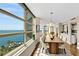 A modern dining room with a large window and view of the bay, plus table for eight at 988 Blvd Of The Arts # 1209, Sarasota, FL 34236