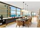A modern dining room with designer lighting fixtures, bay window, and open floor plan at 988 Blvd Of The Arts # 1209, Sarasota, FL 34236