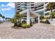 Elegant entrance to the condominium with beautiful landscaping and a covered portico at 988 Blvd Of The Arts # 1209, Sarasota, FL 34236