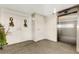 Hallway leading to the unit entrance with an elevator and stylish decor, offering convenience and sophistication at 988 Blvd Of The Arts # 1209, Sarasota, FL 34236