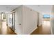 Hallway with gleaming hardwood floors leading to a bright room with water views, offering a seamless transition at 988 Blvd Of The Arts # 1209, Sarasota, FL 34236