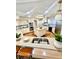 An open concept kitchen features a central island and a breakfast bar with stylish pendant lighting at 988 Blvd Of The Arts # 1209, Sarasota, FL 34236