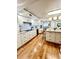 A well-lit kitchen featuring a large island, stainless steel appliances, and hardwood flooring at 988 Blvd Of The Arts # 1209, Sarasota, FL 34236