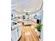 Bright kitchen features hardwood floors, an island with bar seating, and white cabinets at 988 Blvd Of The Arts # 1209, Sarasota, FL 34236