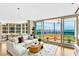 Beautifully decorated living room showcasing waterfront views from a private balcony at 988 Blvd Of The Arts # 1209, Sarasota, FL 34236