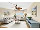 The living room features neutral furniture, a ceiling fan, and artwork that creates a cozy atmosphere for residents at 988 Blvd Of The Arts # 1209, Sarasota, FL 34236