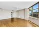Open living room with hardwood floors and large windows showcasing city views at 988 Blvd Of The Arts # 1209, Sarasota, FL 34236