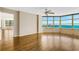 Spacious living room with hardwood floors, large windows with views of the water and city at 988 Blvd Of The Arts # 1209, Sarasota, FL 34236