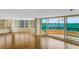 Bright living room showcasing wood floors, floor-to-ceiling windows, and a private balcony at 988 Blvd Of The Arts # 1209, Sarasota, FL 34236