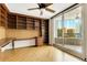 Office with custom shelving leads to private balcony with ocean views and seating at 988 Blvd Of The Arts # 1209, Sarasota, FL 34236