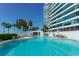 Resort-style pool with plenty of lounge chairs and lush tropical landscaping at 988 Blvd Of The Arts # 1209, Sarasota, FL 34236