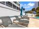 Inviting community pool area with lounge chairs, umbrellas, and convenient access to residential buildings at 988 Blvd Of The Arts # 1209, Sarasota, FL 34236