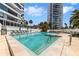 Beautiful waterfront pool with easy access and lush landscaping surrounding it at 988 Blvd Of The Arts # 1209, Sarasota, FL 34236