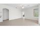 Open living area with tile floor, ceiling fan, and natural light at 11019 Water Lily Way, Lakewood Ranch, FL 34202