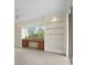 Home office featuring a built-in desk, shelving, and natural light, providing a comfortable workspace at 11019 Water Lily Way, Lakewood Ranch, FL 34202