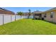 Spacious backyard with lush green grass and a privacy fence for outdoor enjoyment at 115 64Th E Ave, Bradenton, FL 34203