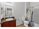 Bathroom featuring a vanity with a granite counter top and nautical themed shower curtain at 115 64Th E Ave, Bradenton, FL 34203