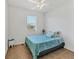 Cozy bedroom featuring a ceiling fan, small window, and a twin bed with blue comforter at 115 64Th E Ave, Bradenton, FL 34203