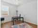 Bright bedroom featuring a ceiling fan, a window with blinds, and a dark table with a chair at 115 64Th E Ave, Bradenton, FL 34203
