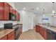Updated kitchen featuring stainless steel appliances, dark wood cabinets, and tile floors at 115 64Th E Ave, Bradenton, FL 34203