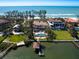 Breathtaking aerial view of an estate home with pool, a private dock, and stunning ocean views at 1216 N Casey Key Rd, Osprey, FL 34229