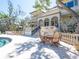 Outdoor patio area with dining set, lounge chairs, and pool, perfect for relaxation and entertaining at 1216 N Casey Key Rd, Osprey, FL 34229