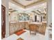 Spacious bathroom featuring custom cabinetry, marble counters, and decorative lighting at 1216 N Casey Key Rd, Osprey, FL 34229