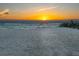 Scenic beach view with calm waters, golden sunset, and serene sandy shore at 1216 N Casey Key Rd, Osprey, FL 34229