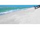 Sandy beach with gentle waves and a view of the coastline, adjacent to the property at 1216 N Casey Key Rd, Osprey, FL 34229