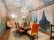Elegant dining room featuring a mural, chandelier, and oval table with seating for eight at 1216 N Casey Key Rd, Osprey, FL 34229