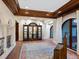 Spacious entryway with wood flooring, arched windows, wooden accents, and display cabinet at 1216 N Casey Key Rd, Osprey, FL 34229