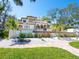 Landscaped home exterior with balconies, manicured grounds, and a winding brick path at 1216 N Casey Key Rd, Osprey, FL 34229