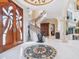 Grand foyer with a spiral staircase, marble floors, decorative medallion, and elegant architectural details at 1216 N Casey Key Rd, Osprey, FL 34229
