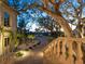 Beautifully landscaped front yard with a paved driveway and mature trees at 1216 N Casey Key Rd, Osprey, FL 34229