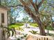 Beautiful front yard with a circular driveway, lush landscaping, and direct access to a pristine beach at 1216 N Casey Key Rd, Osprey, FL 34229