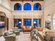 Spacious living room with soaring ceilings, elegant furnishings, and expansive windows showcasing beautiful views at 1216 N Casey Key Rd, Osprey, FL 34229