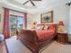 Comfortable main bedroom with a tray ceiling and access to a private balcony at 1216 N Casey Key Rd, Osprey, FL 34229